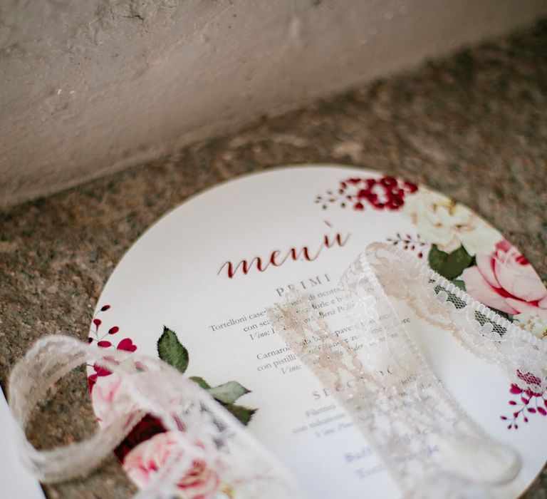 Round wedding menu stationery with red rose illustrations and lace ribbon