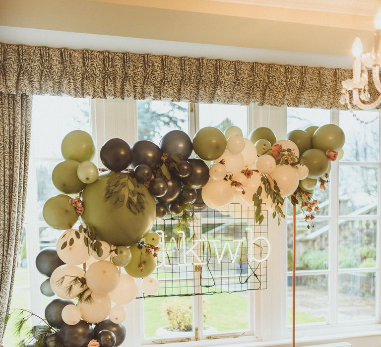 Green and white balloon arch wedding decor