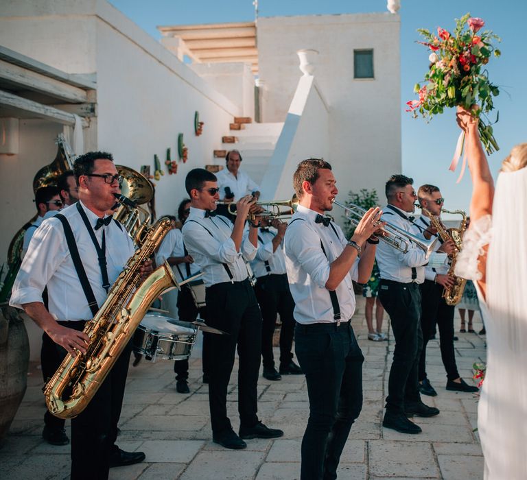 The bride and guests dancing to Zagor Street Band at their outdoor reception