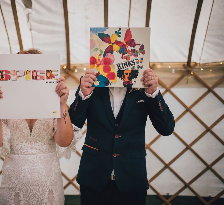 Bride & groom hold up records in yurt