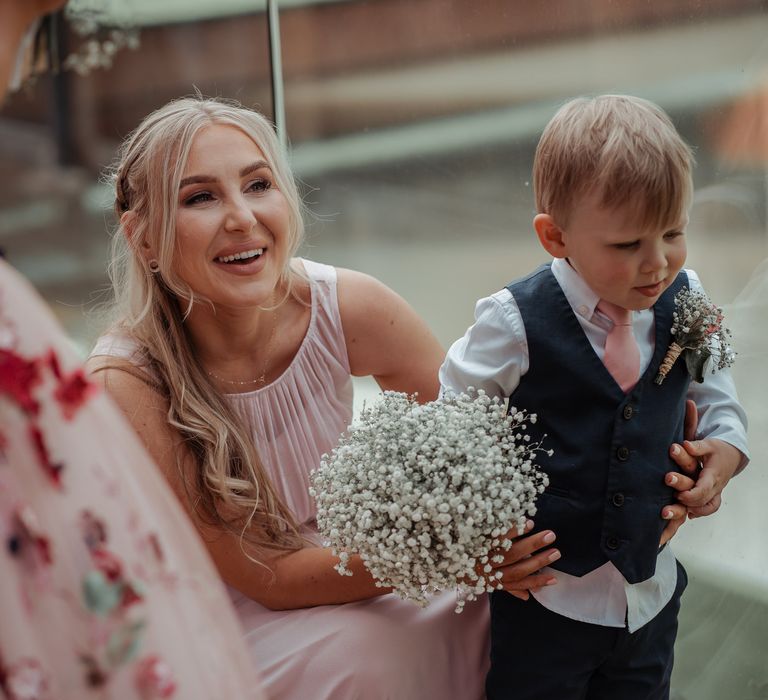 Bridesmaid stands with little boy