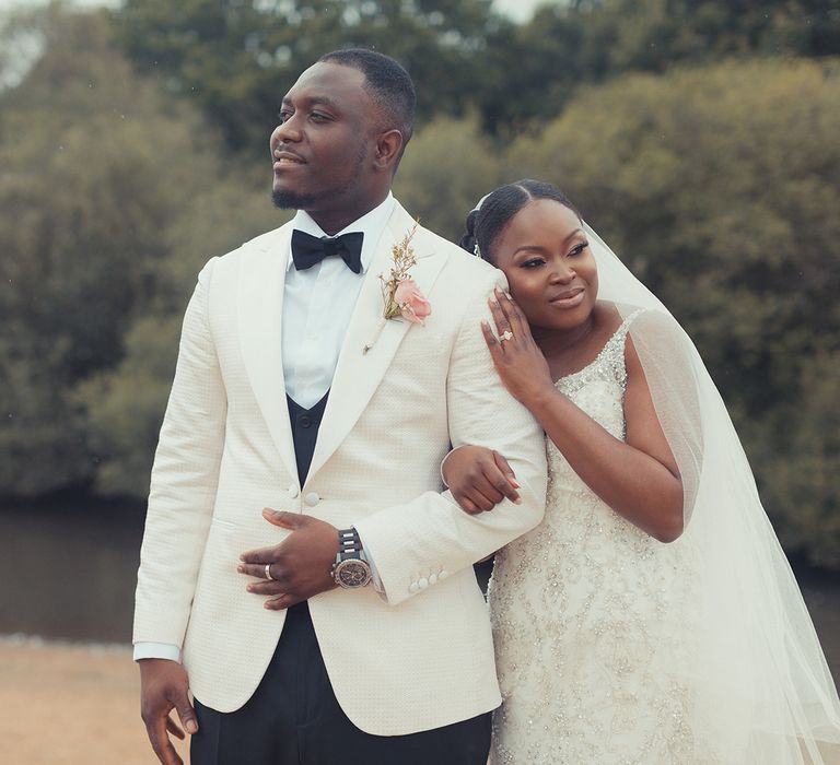 Bride links arms with her groom outdoors on their wedding day