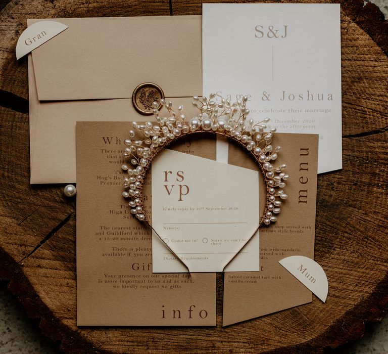 Neutral wedding invitations and pearl wedding hair accessory by Garter & Veil