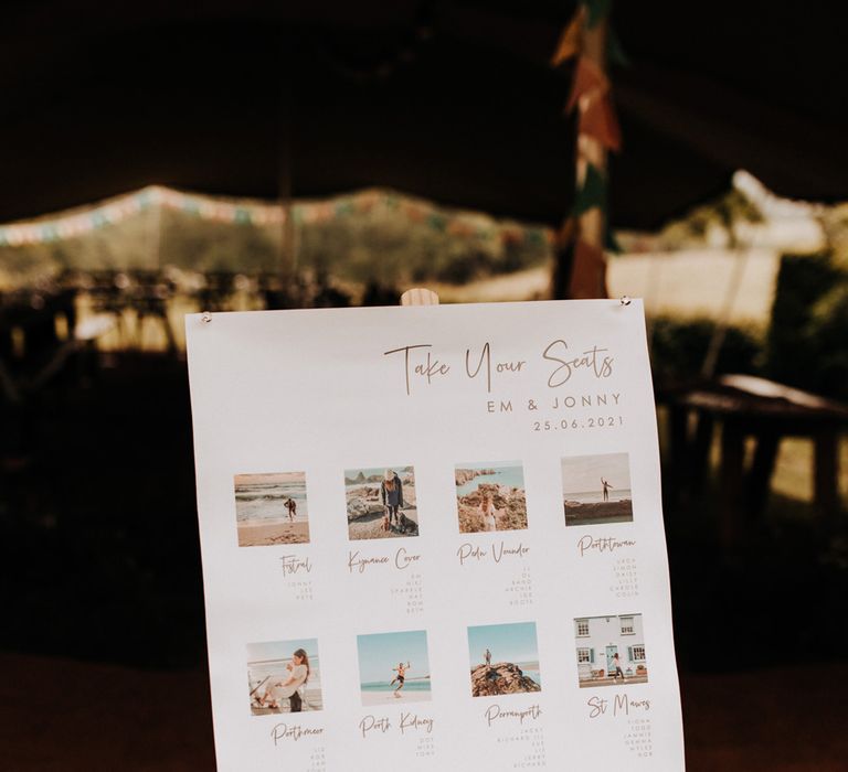 White wedding table plan on pine wood easel with photos and title reading 'Take Your Seats'