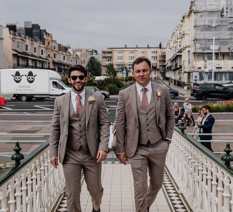 Best men arrive at wedding in grey suits