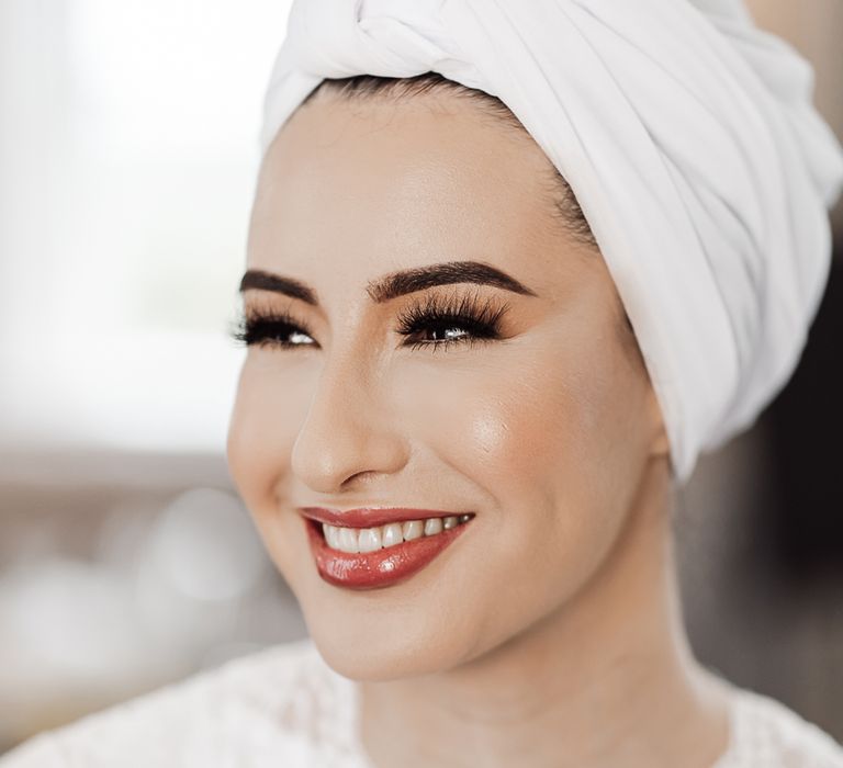 Muslim bride with a glossy lipstick and long false eyelashes 