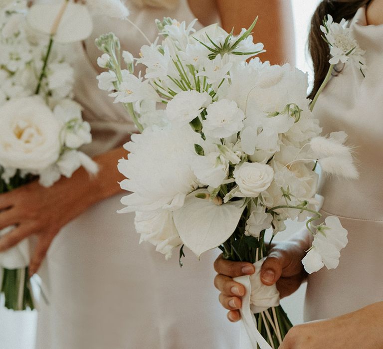 All white wedding bouquet with peonies, roses and anthuriums