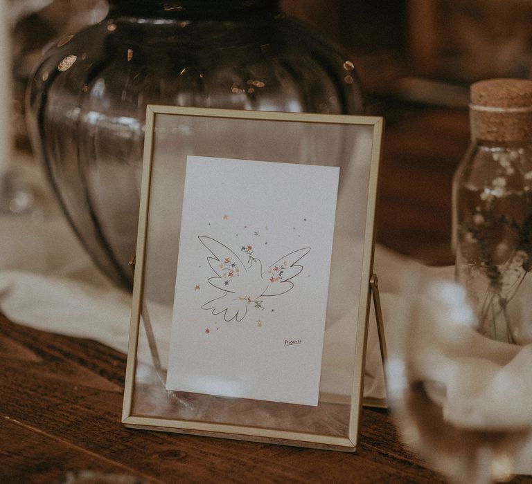 Beautiful framed illustrations on wedding tables