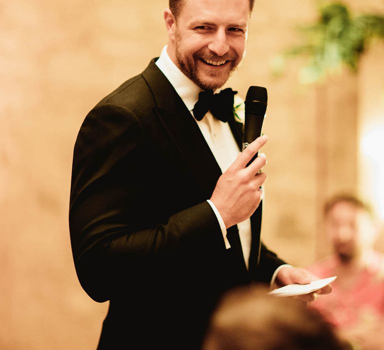 Groom gives speech on his wedding day whilst wearing black tie