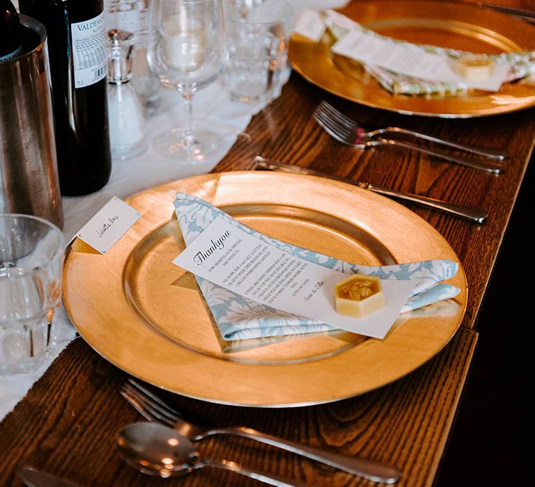 Gold plate complete with pale blue napkin and white stationery