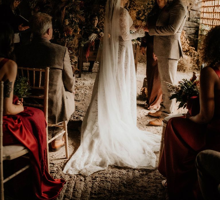 Lyde Court wedding ceremony with autumnal flowers and bride in a lace wedding dress and cathedral length Juliet cap veil 