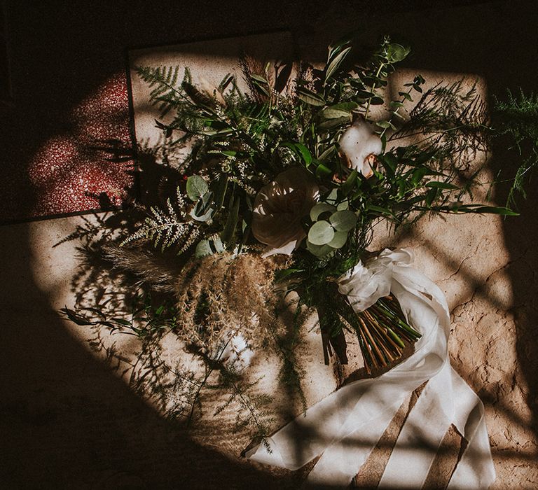 Bridal bouquet tied with white ribbon