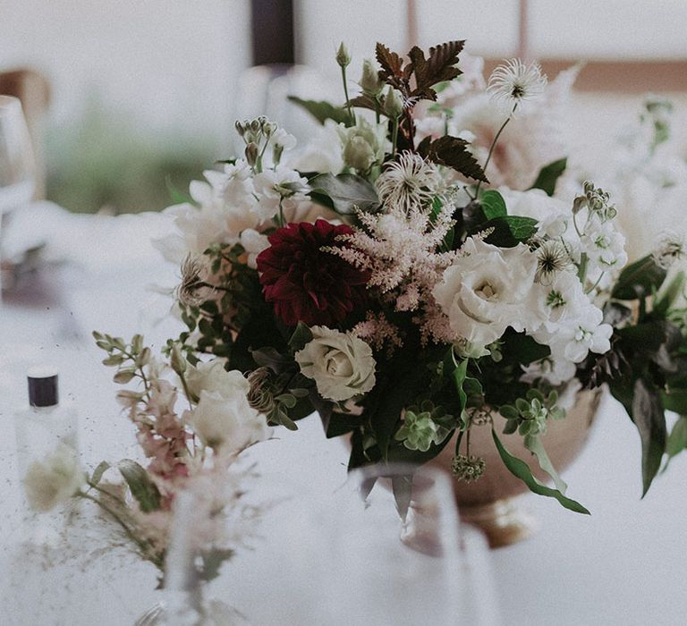 Small arrangement of wedding flowers for the table setting including white, green, red and pink flowers 