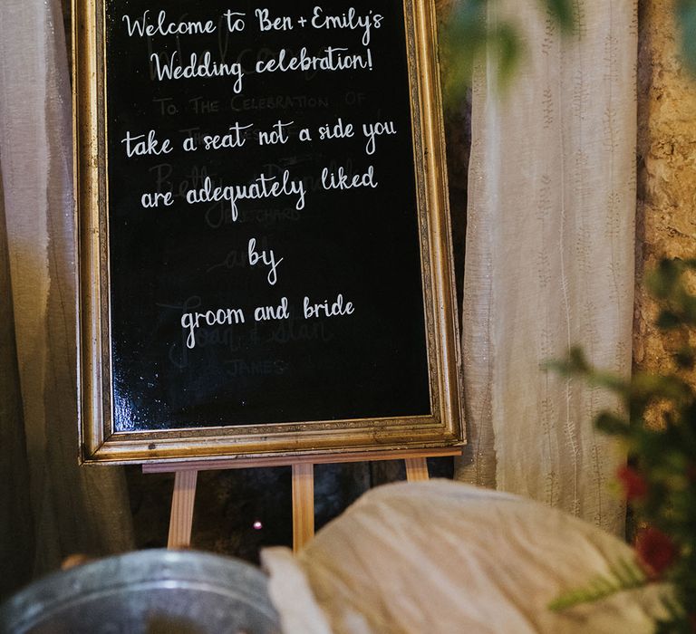 Chalk board style welcome wedding sign guiding guests where to sit