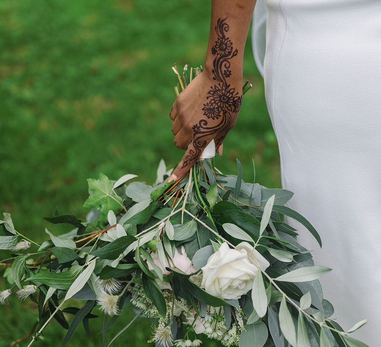 White rose bridal wedding bouquet held by bride