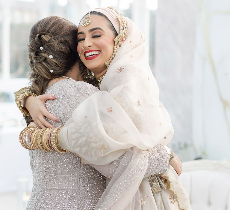 Bride hugs friend on her wedding day at the Isla Gladstone Conservatory