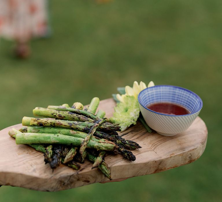 Grilled asparagus on wooden board 