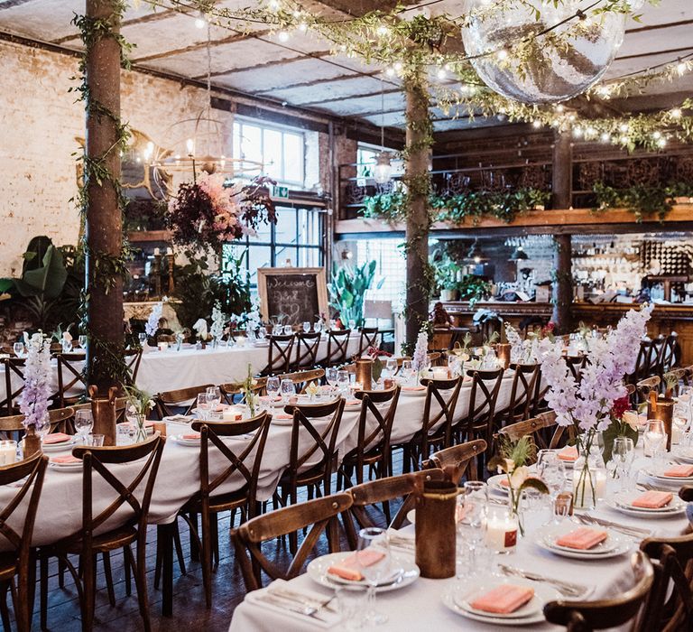 Clapton Country Club wedding venue decorated with foliage and a large disco ball 