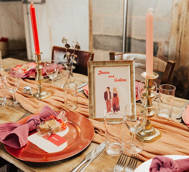 Red and pink candles with retro table name in a gold photo frame with vegan fudge favours 