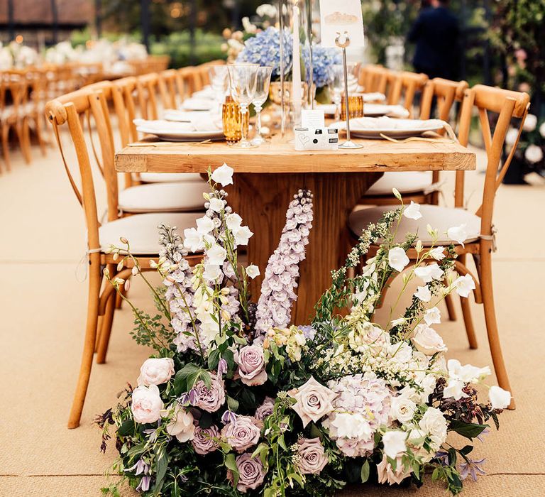 Pale pastel wedding flower decor for English country garden style wedding in a glass marquee reception 