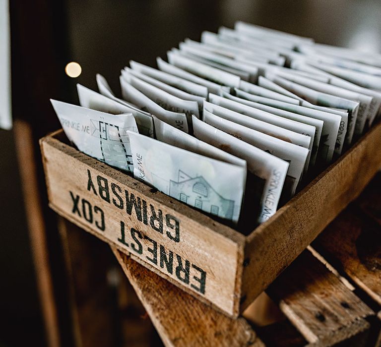 Confetti packages in DIY envelopes in wooden box