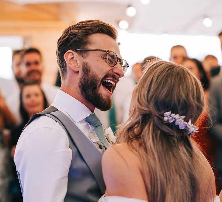 Groom sings to the first dance song passionately with the bride at their festival marquee style wedding 