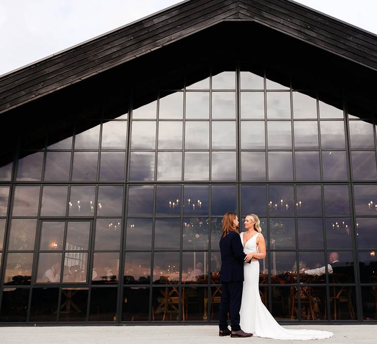 Botley Hill Barn wedding venue with incredible windows featuring the bride and groom 