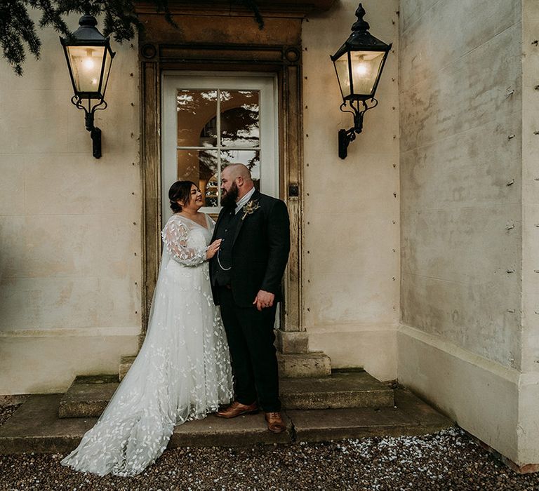 Groom in green tweed wedding suit with the bride in lace wedding gown at Aswarby Rectory in Lincolnshire 