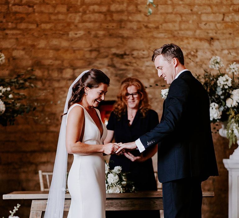 The bride and groom exchange wedding rings for their civil ceremony 