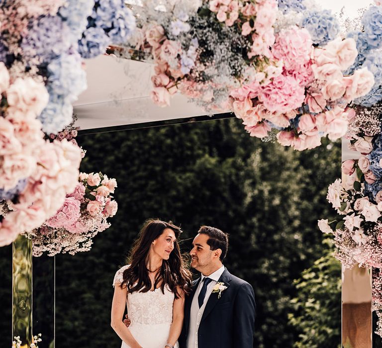 The bride and groom at their outdoor wedding ceremony at the Four Seasons Hampshire 