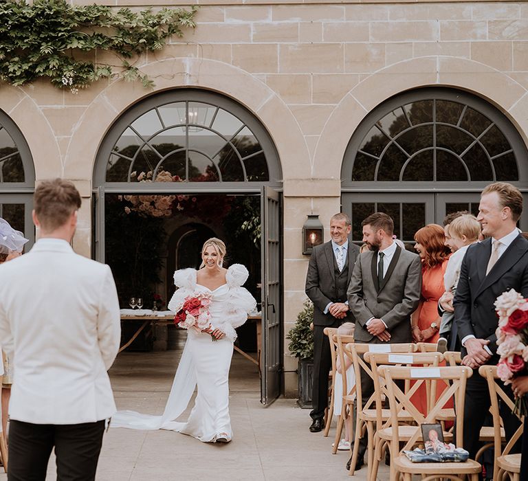 Middleton Lodge outdoor wedding ceremony with the bride walking herself down the aisle to the groom 