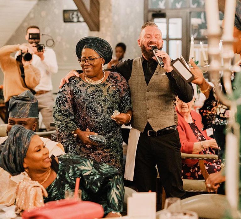 Wedding entertainment at multicultural real wedding with singing waiter singing with wedding guest 