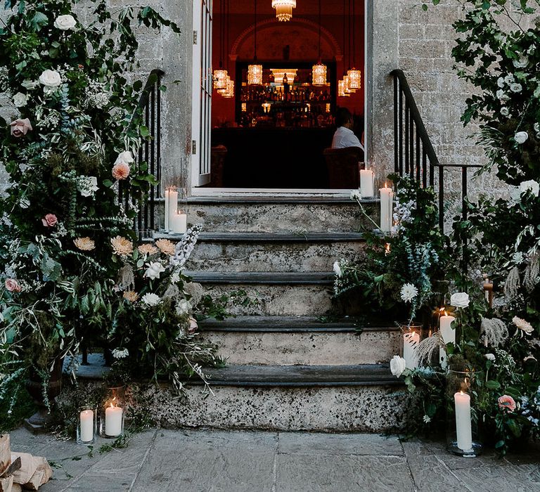 Babington House wedding venue decorated with white flower columns 