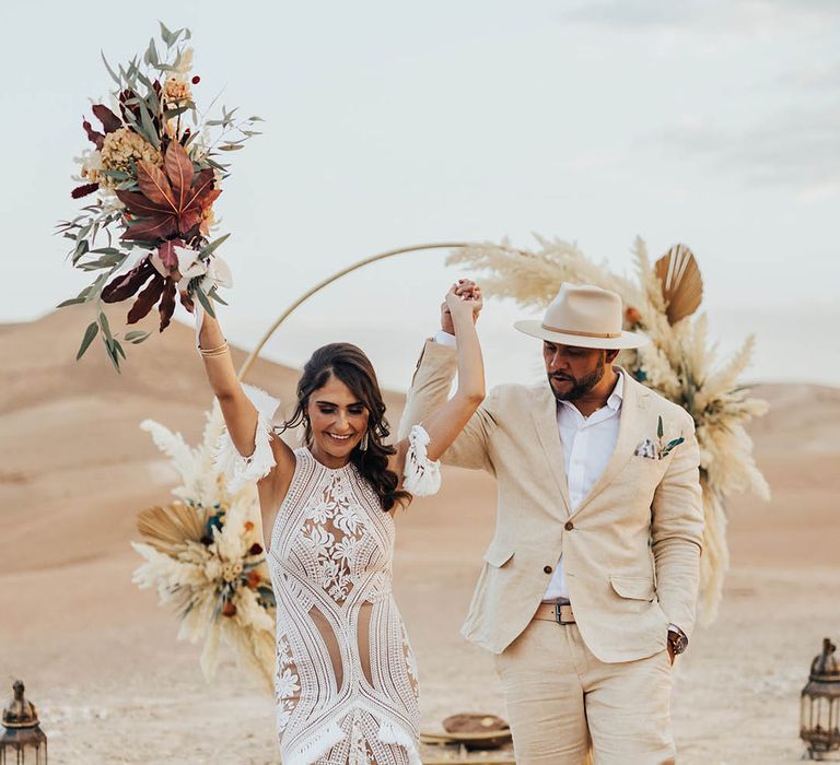 Bride and groom celebrate their wedding ceremony with confetti 