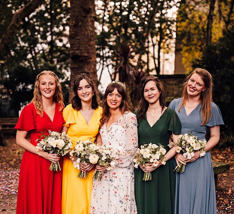 Rainbow coloured mismatched bridesmaid dresses for colourful wedding