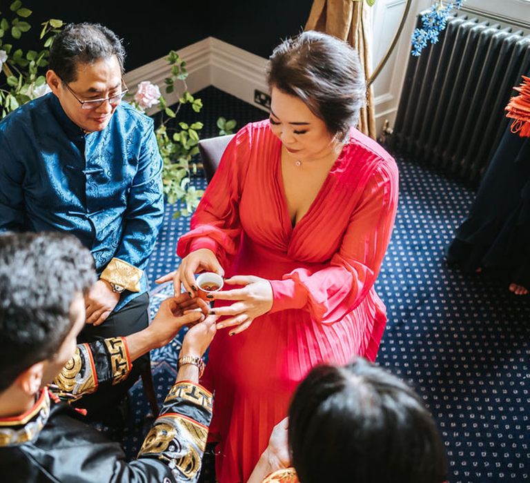 Groom gives mother of the bride tea as a part of the traditional Chinese Tea Ceremony 