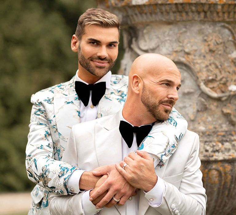 The two grooms pose for their couple portraits together in black tie 