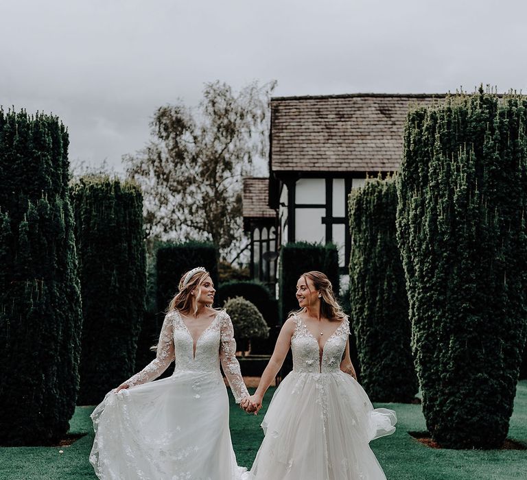 Brides in princess wedding dresses at garden elopement 