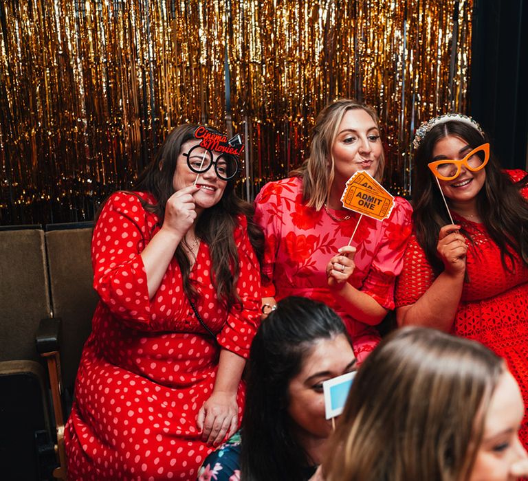 Rustic barn wedding with guests using the photobooth with props 