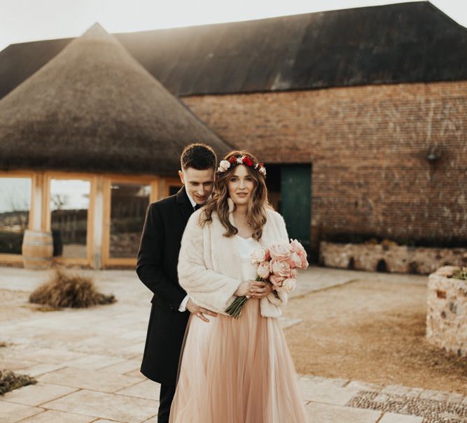 Couple on wedding day at Brickyard Vineyard with blush tulle skirt