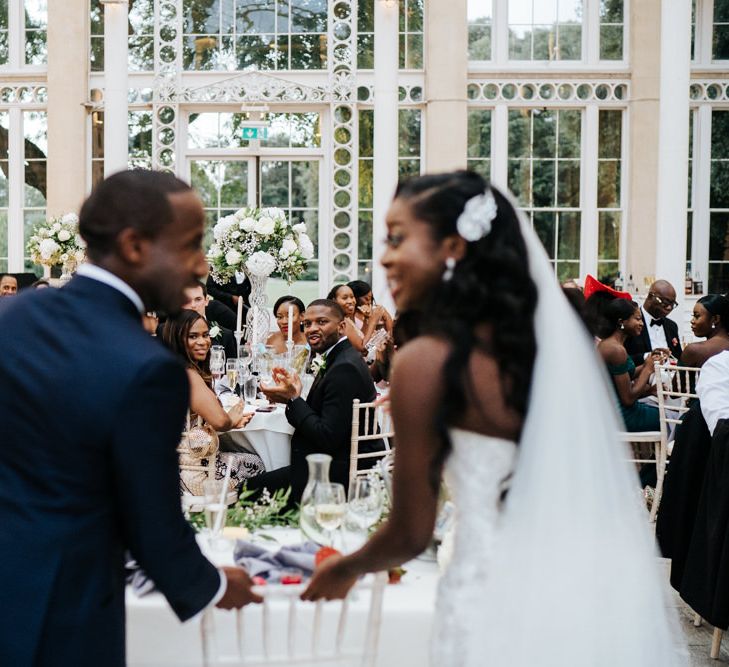 Bride and groom standing at their sweetheart table 