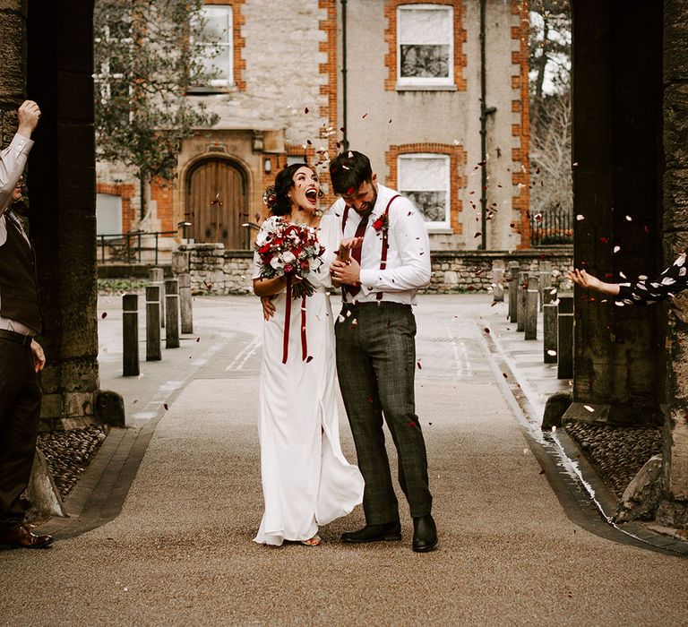 Bride and Groom with red and white confetti in Oxford