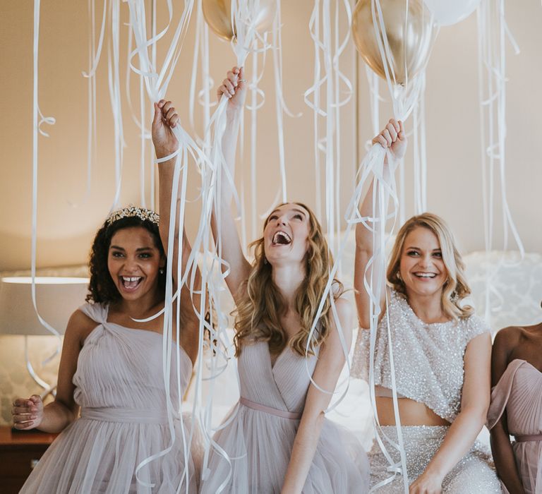 Bridal party wedding morning preparations with metallic helium balloon decor 