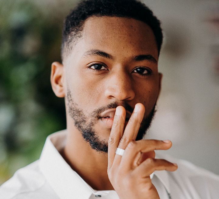 Black bearded groom with open white shirt 