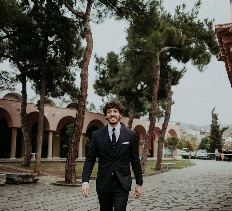 The groom arriving to their Greek church wedding ceremony