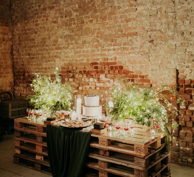 DIY rustic wedding table decor made out of wooden pallets and fairy lights