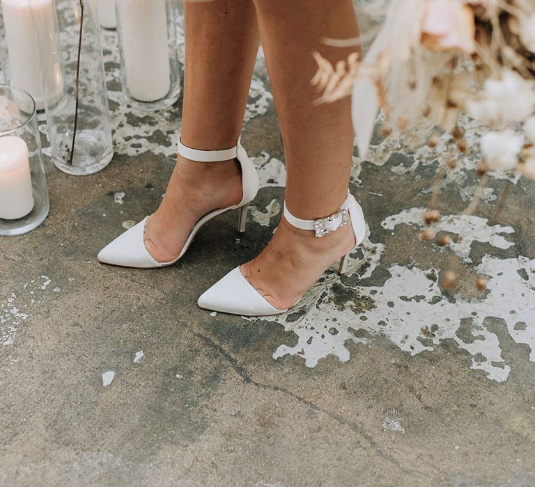 Pointed strappy white wedding heels with diamond buckle for an all white wedding