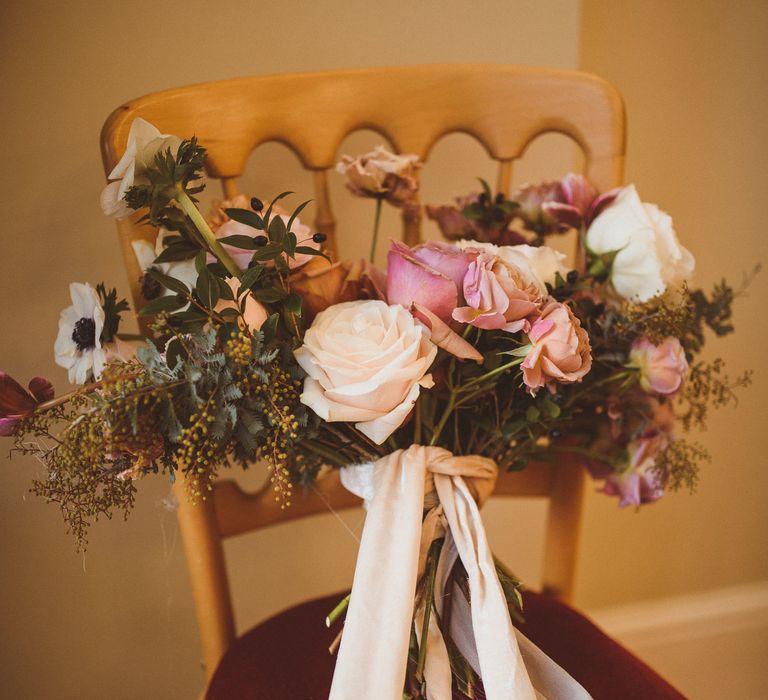 Romantic blush pink and foliage wedding bouquet tied with ribbon 