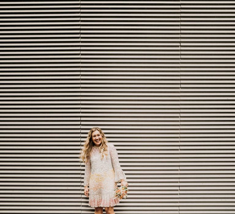 Bride wearing white, cream pink, yellow and silver wedding dress for micro wedding in Manchester