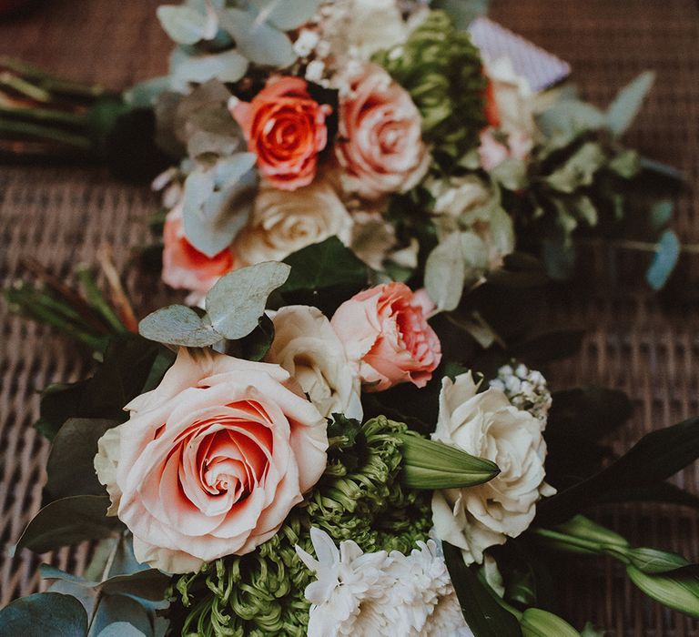 White and peach rose bouquets with green foliage 